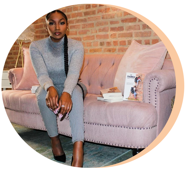 Brittany Rogers seated on a pink couch